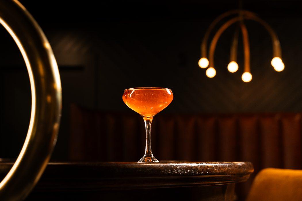 Signature cocktail in speakeasy setting